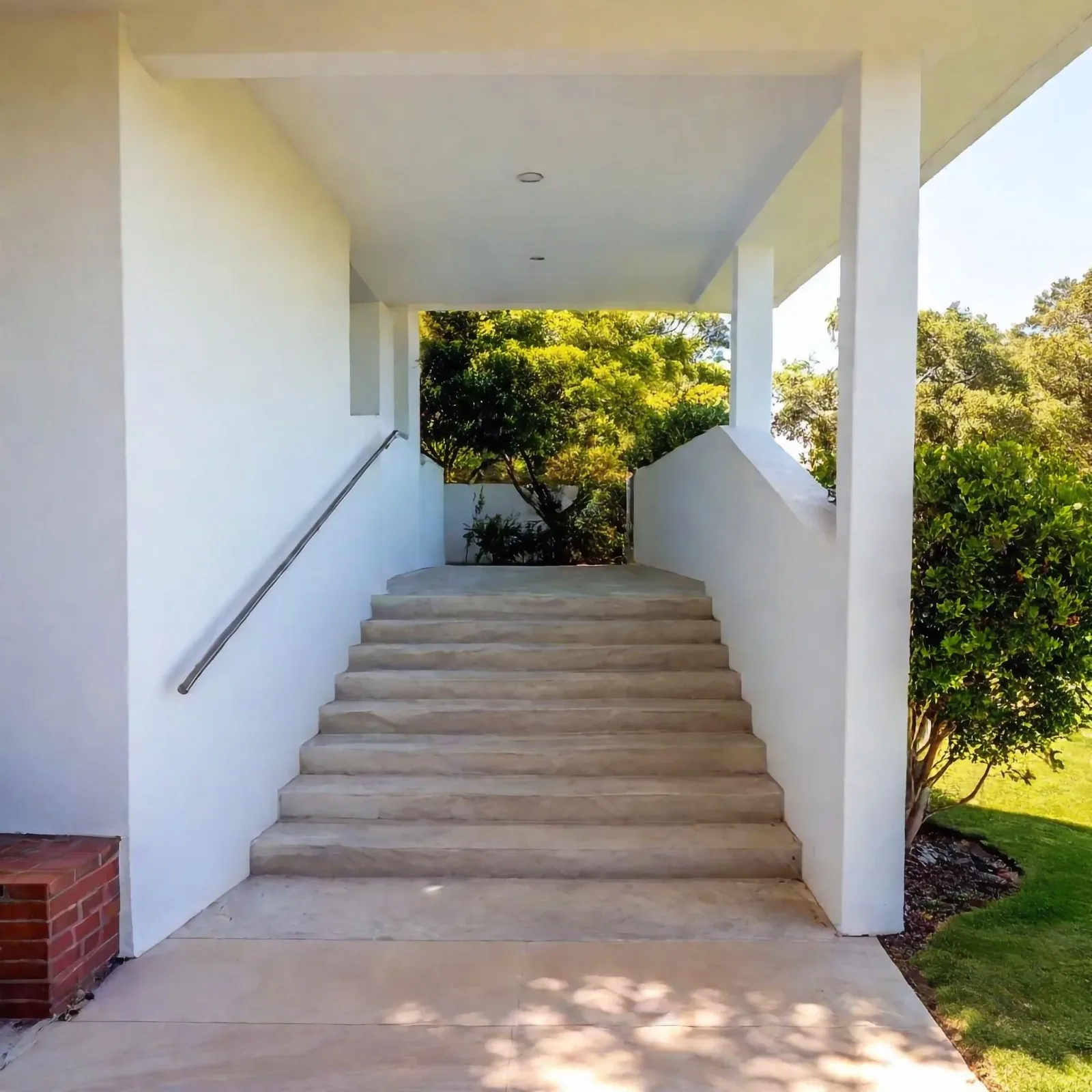 Concrete steps finished under a covered entry