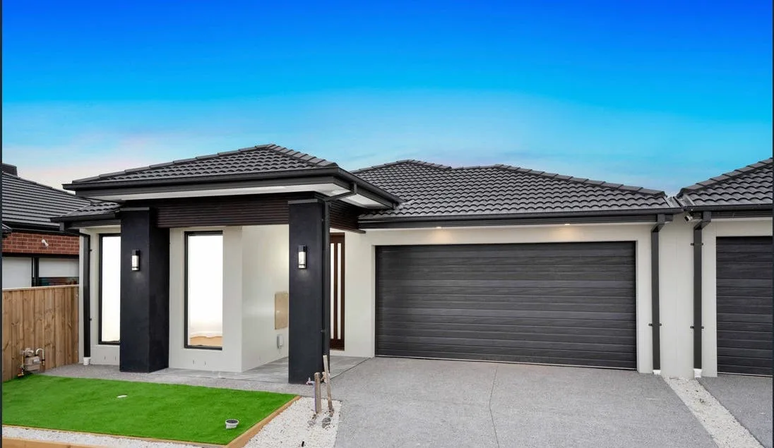 Plain concrete driveway finished for a Peninsula home at dusk