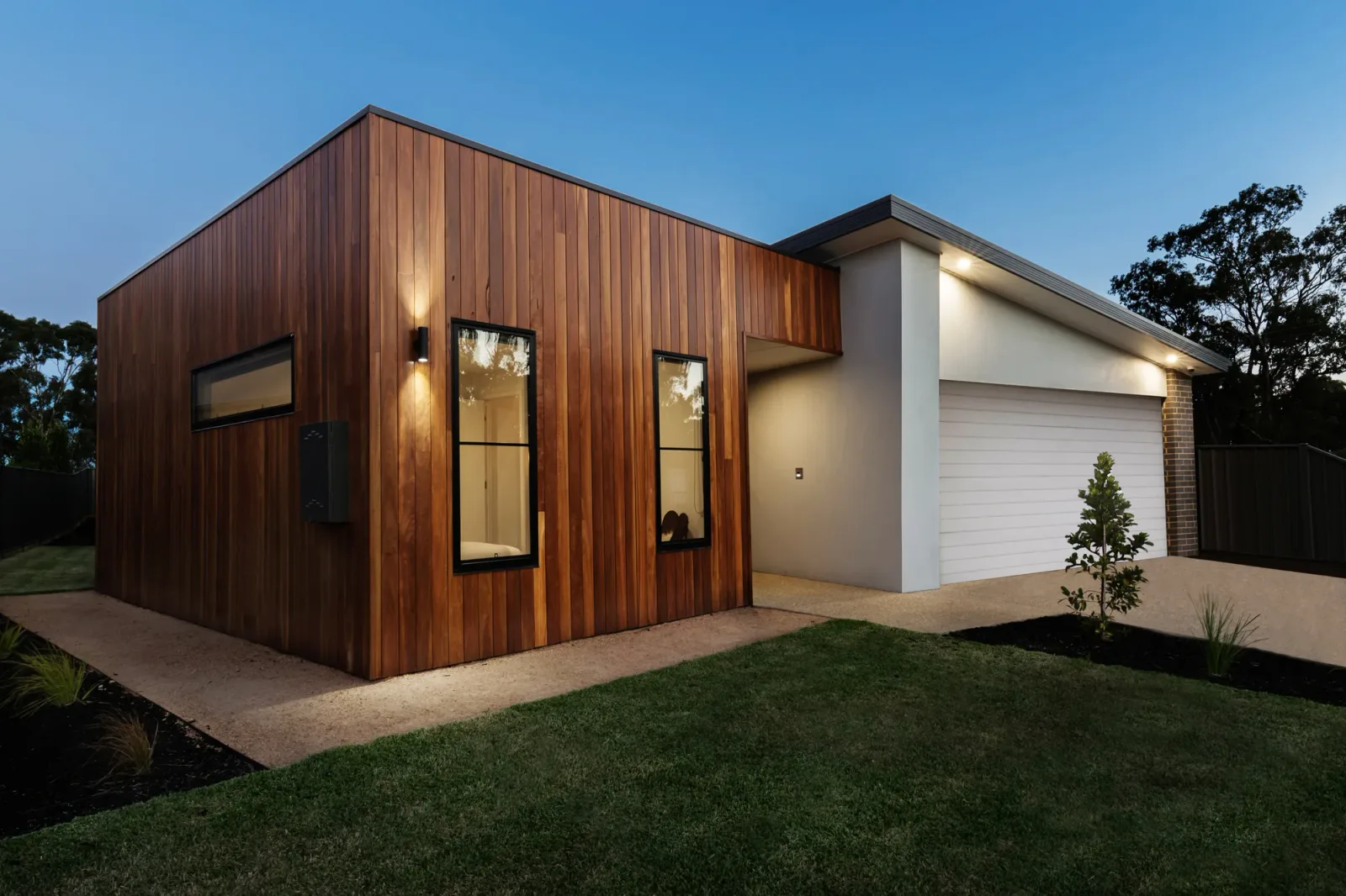 Concrete driveway and path finished for a timber-clad home