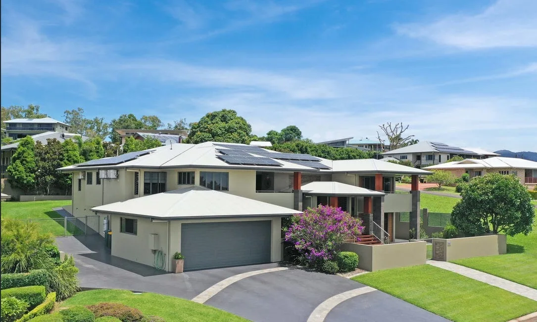 Concrete driveway finished for a home with solar panels