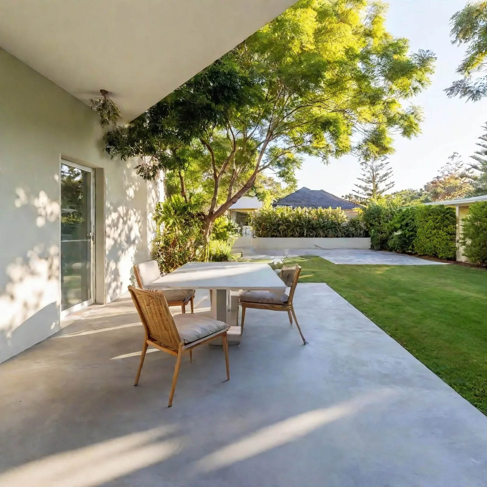 Concrete patio under a shaded pergola
