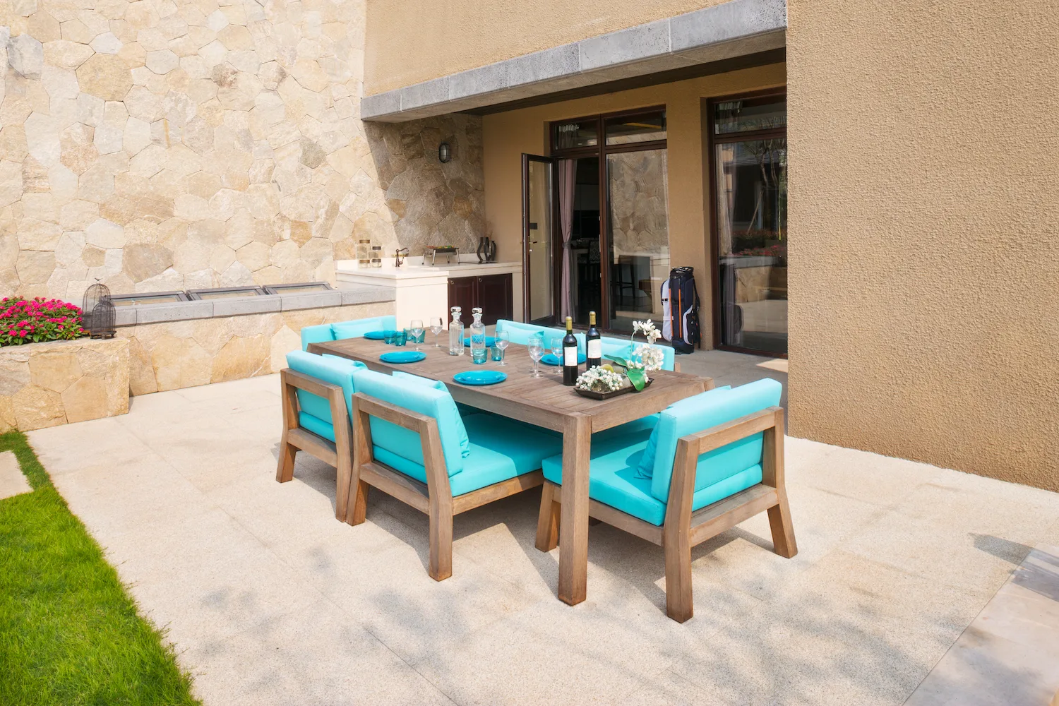 Concrete patio finished beside a rendered courtyard wall