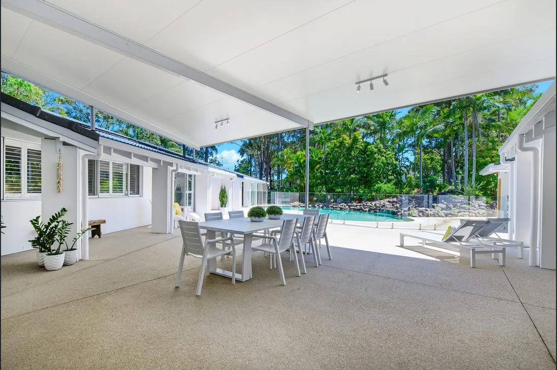 Covered alfresco patio finished beside a pool