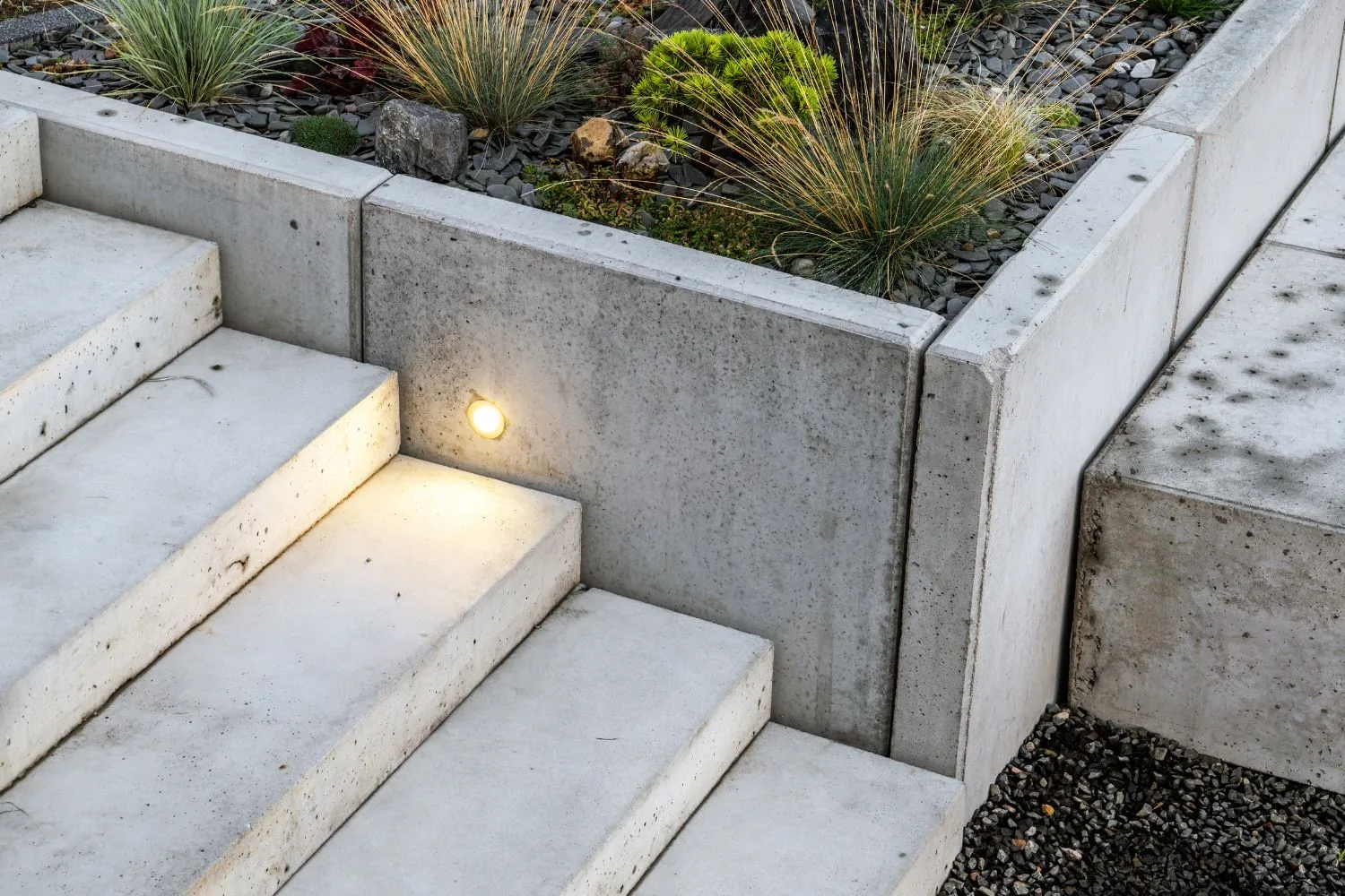 Concrete steps finished beside a raised garden bed